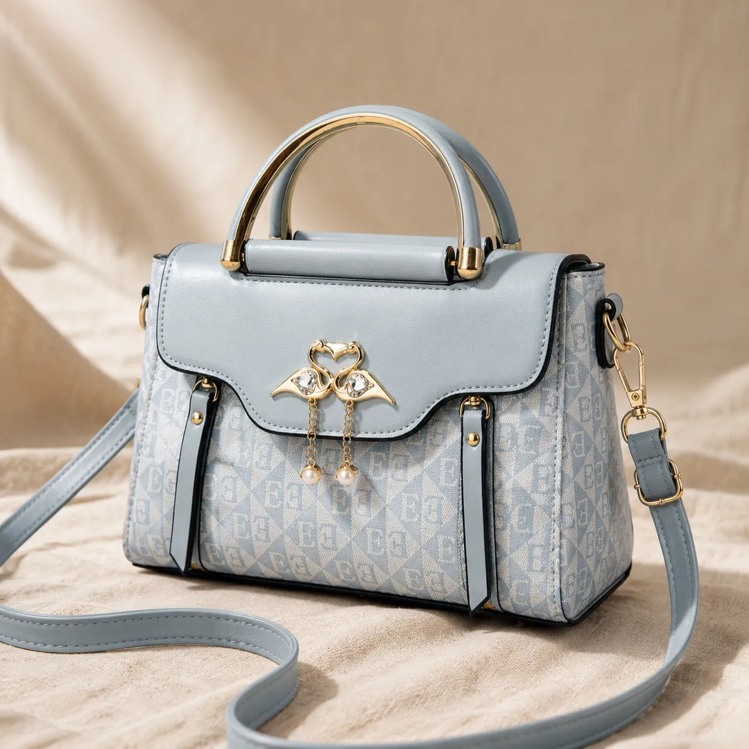 Velora – Torebka crossbody z zapięciem w kształcie łabędzia i złotymi akcentami