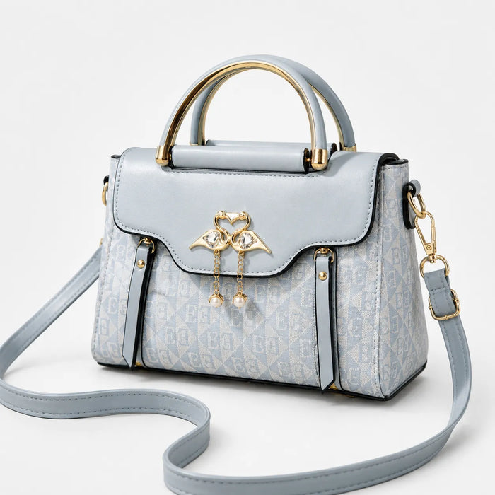 Velora – Torebka crossbody z zapięciem w kształcie łabędzia i złotymi akcentami